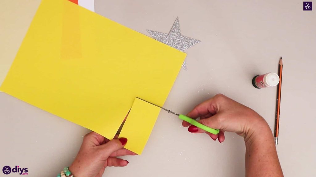 Paper candle on a star lay down yellow paper