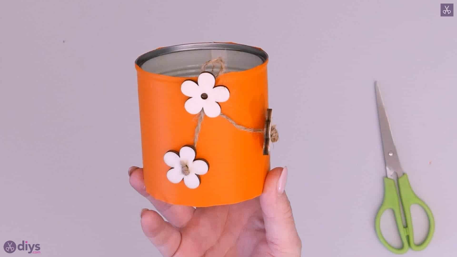 Tin can container with wooden flowers
