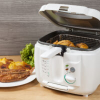 Household kitchen a white automatic electric fryer pot 