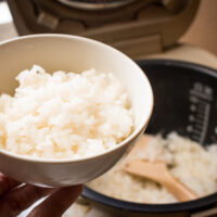 Japanese steamed rice in bowl with rice cooker 