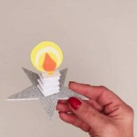 Cropped paper candle on a star jpg