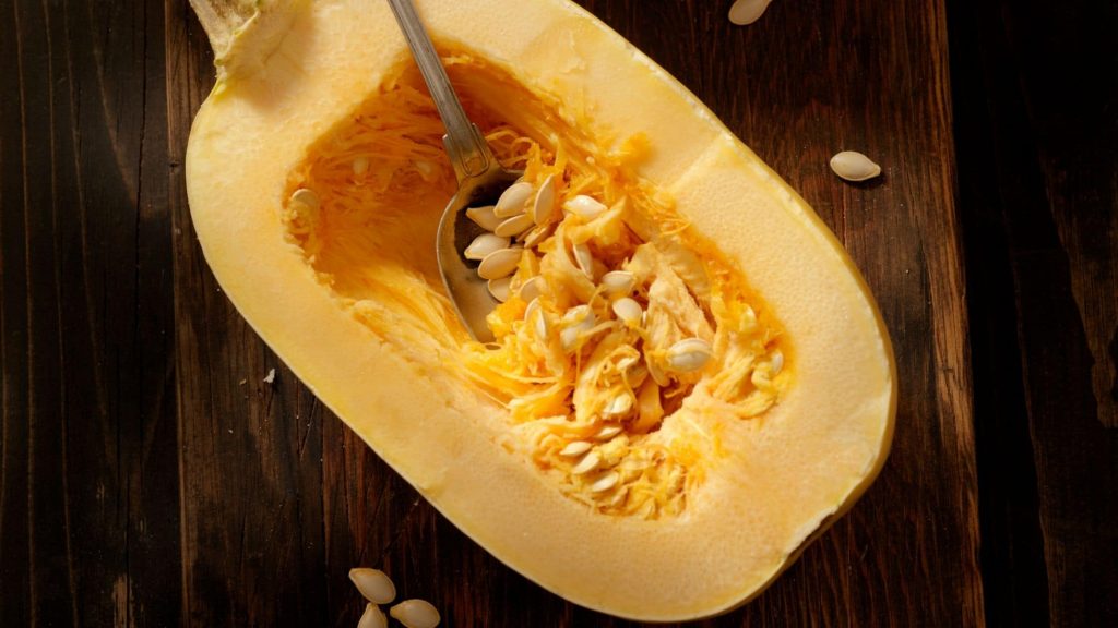 A picture showing how to deseed the spaghetti squash