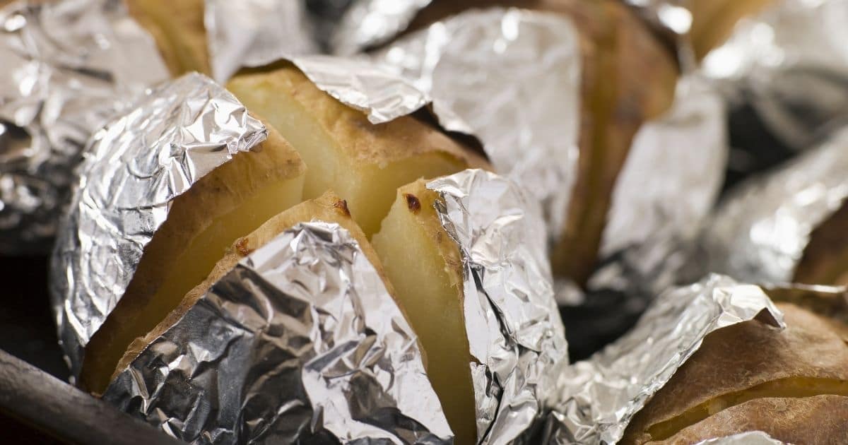 Cooled jacket potatoes wrapped in foil