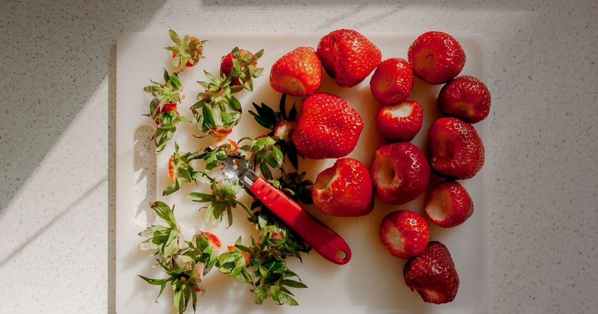 Strawberries being prepared for the freezer