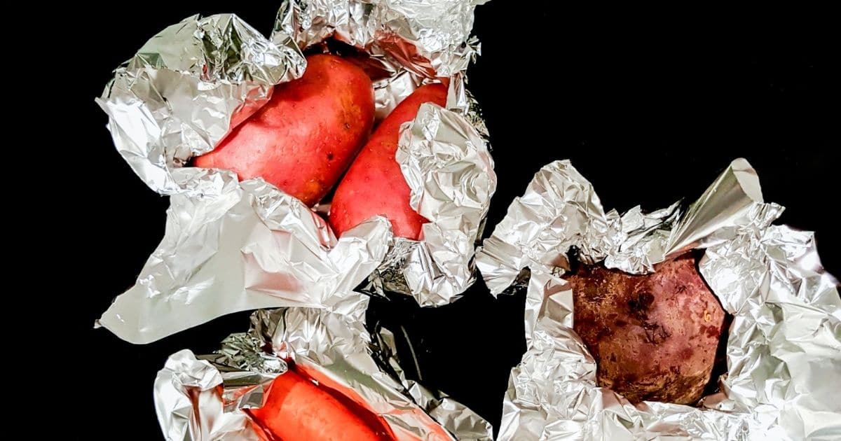 Individual sweet potatoes wrapped in foil