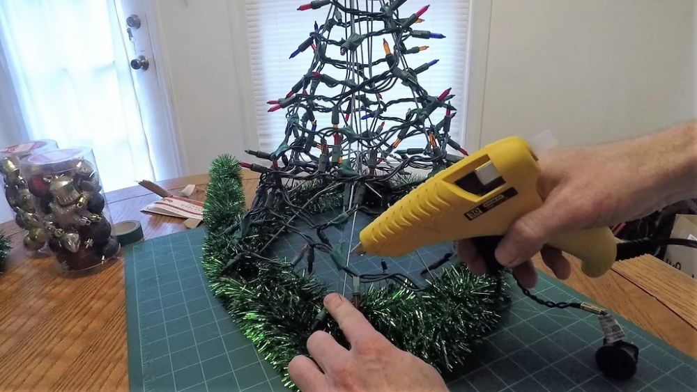 Diy tabletop christmas tree with coat hangers and tinsel