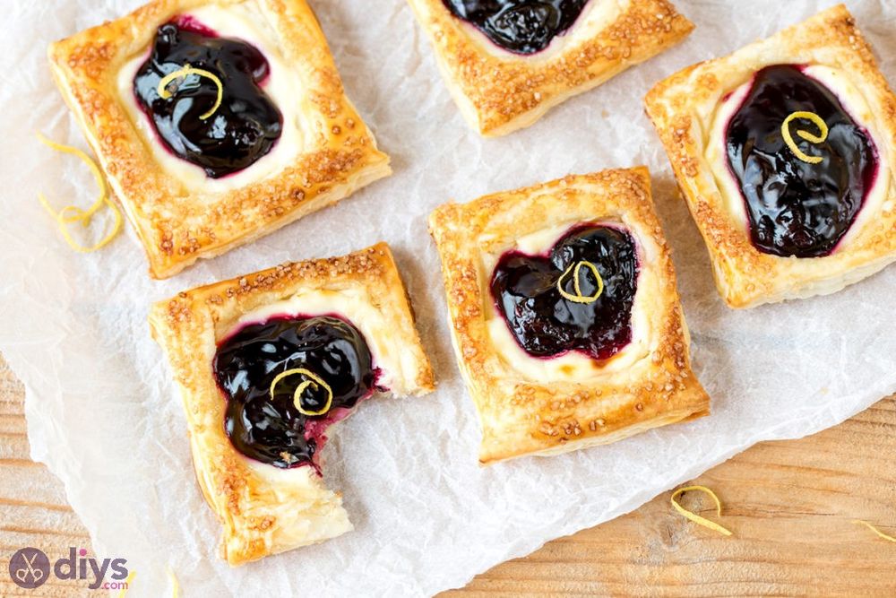 Party food puff pastries with cheesecake and cherries