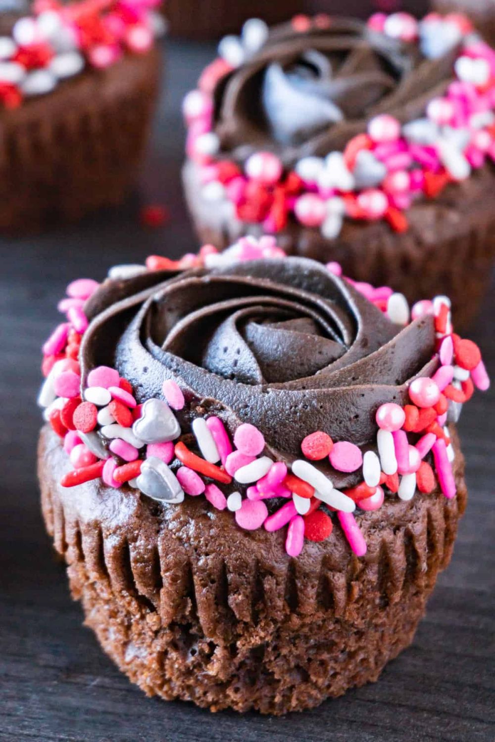 Valentine cupcakes with dark chocolate frosting and sprinkles