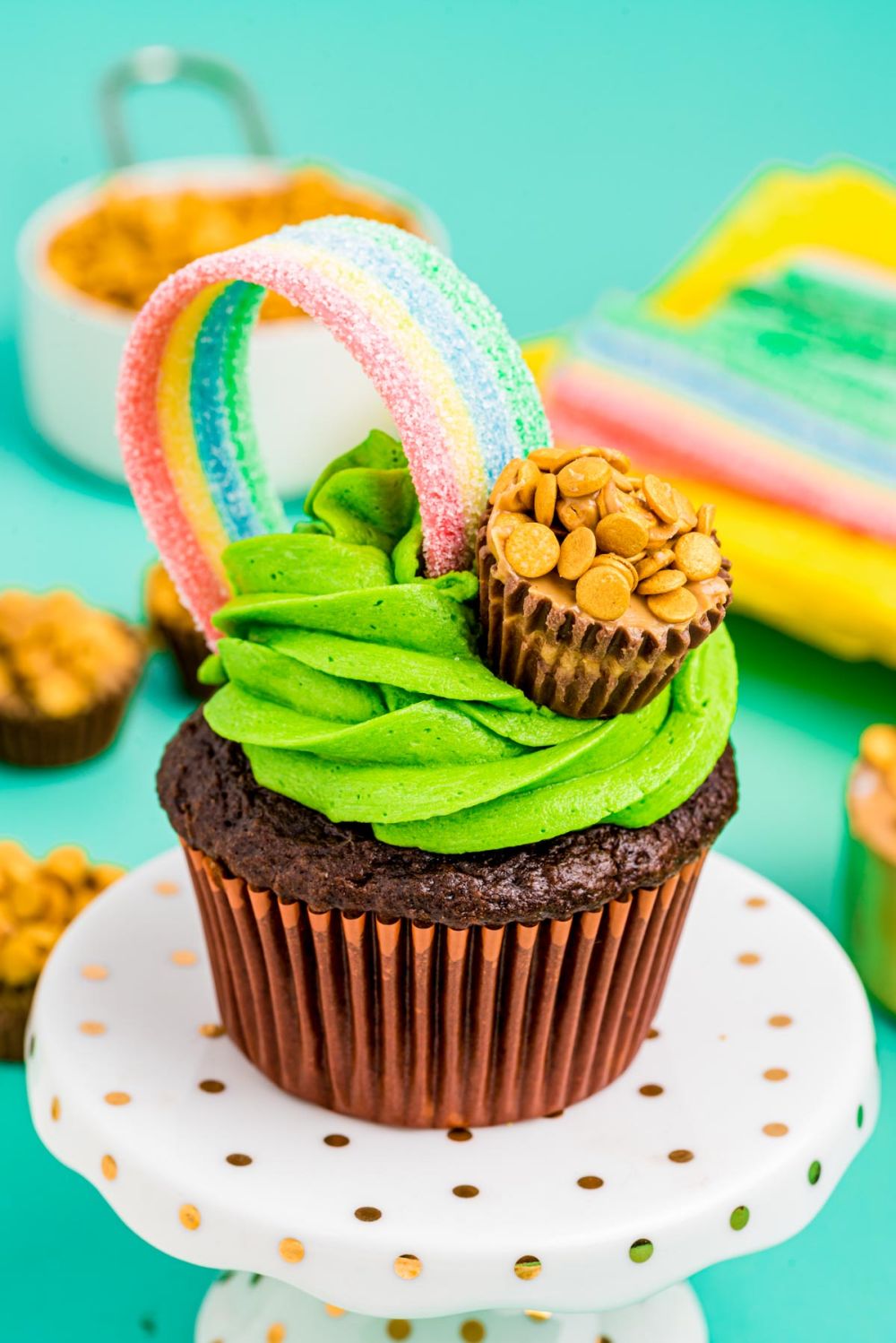 Cupcakes with green frosting and a pot of gold at the end of the rainbow