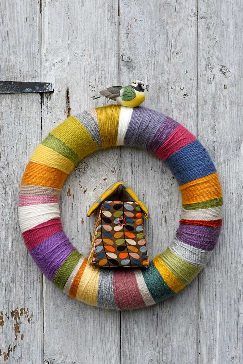 Diy yarn wrapped wreath with birdhouse